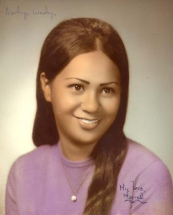 Marvel as a young woman, smiling in a studio portrait, wearing a purple top.