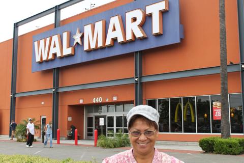 Marvel smiling in front of a Walmart store entrance.